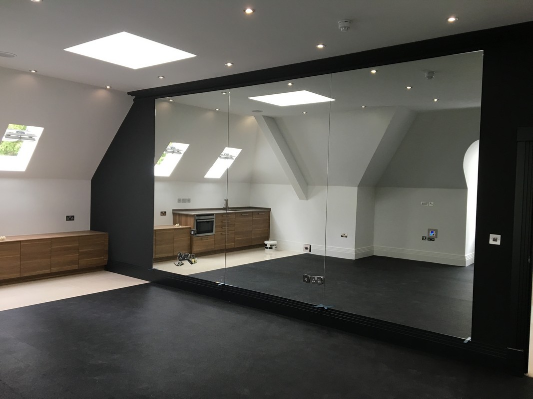 Frameless glass wall dividing loft conversion in Tring